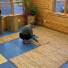 Installing interlocking faux wood foam flooring tiles across a room